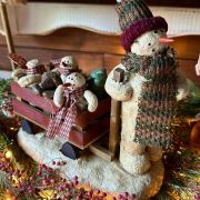 Mamma pupazzo con carretto e i suoi piccolini pupazzetti di neve